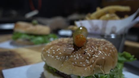 dolly in and out shot of burgers and fries ready to be served to a customer