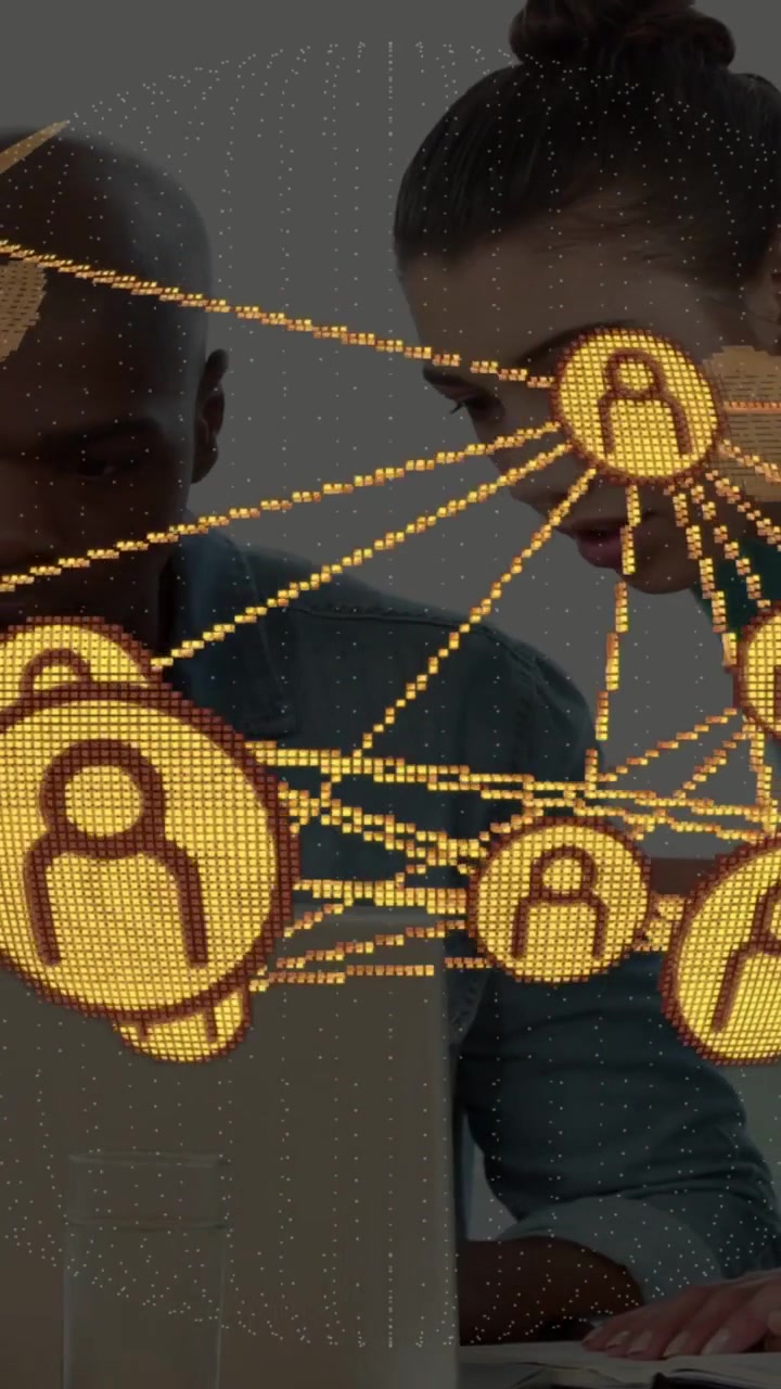 Vertical video: IT team leaning toward laptop in office sparking golden node overlay checking links
