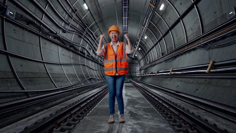 woman engineer celebrating in underground tunnel