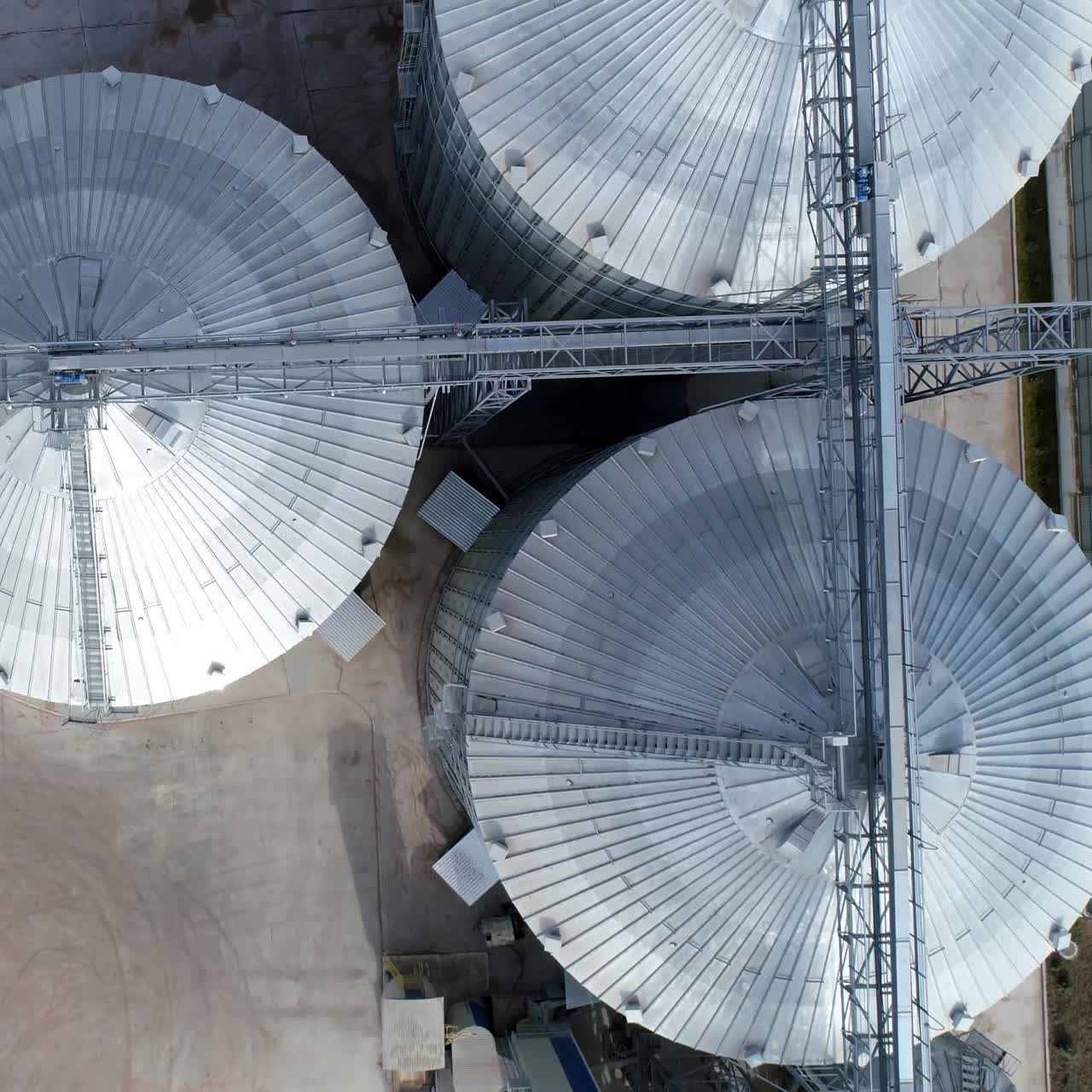 Steel big grain elevators. Industrial grain storage tanks. Arrial view