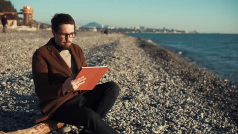 hombre leyendo en una playa