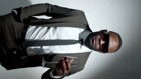 Fashionable-Black-Man-Posing-with-Wine-in-Studio