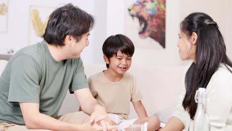 a family supports their child during an emotional moment in a warm, well-lit living room setting