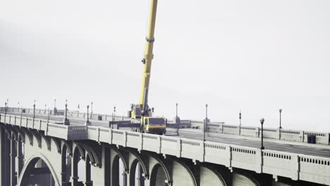 construction equipment working on a bridge during overcast weather