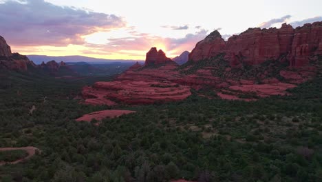 sweeping picturesque vista of merry go round rock sedona arizona at sunset, aerial dolly