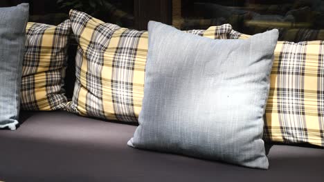 close up of three pillows on a couch