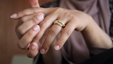 woman's hands with a gold ring