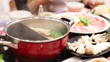 preparing hotpot with fresh ingredients in bangkok