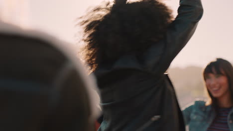 grupo de amigos multirraciales pasando el rato joven afroamericana bailando disfrutando de una fiesta en la azotea al atardecer bebiendo alcohol divirtiéndose en la celebración del fin de semana