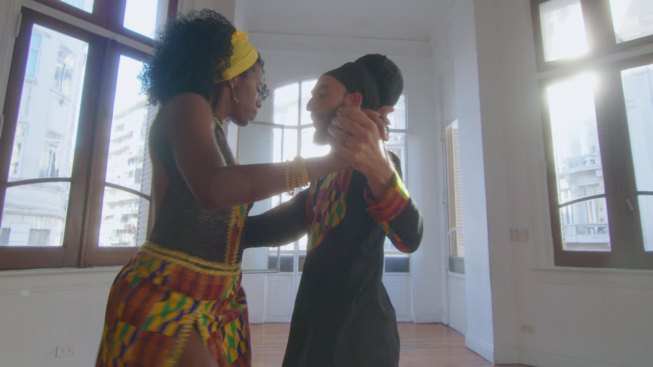 Artistic Couple Dancing Tango in Sunlit Studio