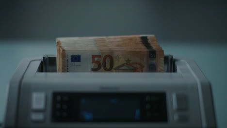 euro banknotes in a bill counter