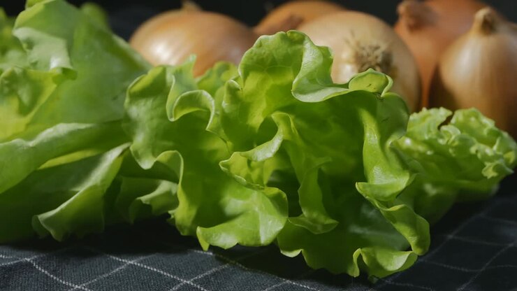 green lettuce and onion in the background. Greens and vegetables rotate. Eco products for healthy and healthy food preparation. Cooking recipes. 4k