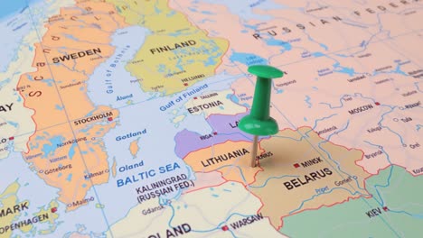 Lithuania---Travel-concept-with-green-pushpin-on-the-world-map.-The-location-point-on-the-map-points-to-Vilnius-the-capital-of-the-Lithuanian.
