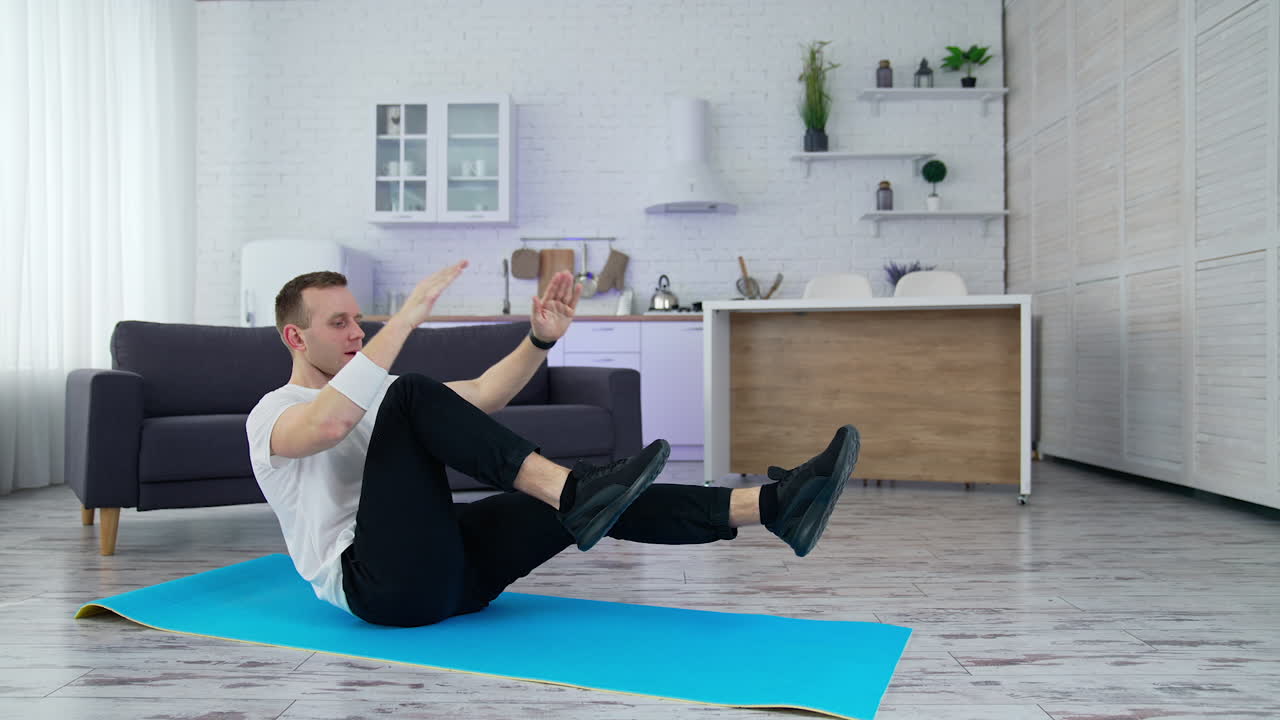 Healthy lifestyle man training his body in home. Strong male working out on quarantine.