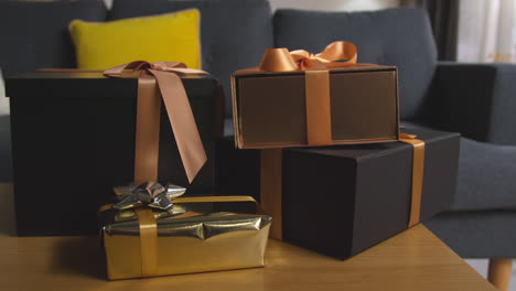 close up of gift wrapped presents on table in lounge at home 2