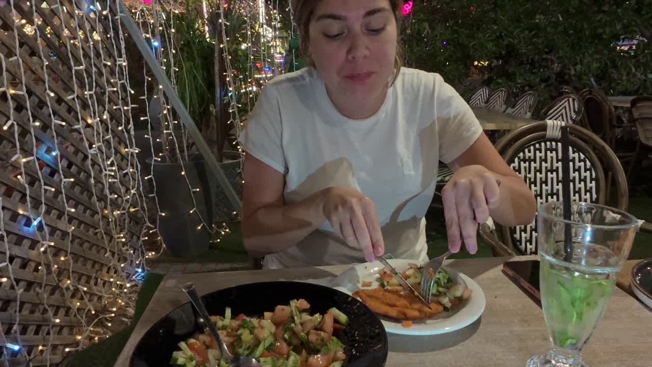 Woman with a Funny Expression While Chewing Her Food