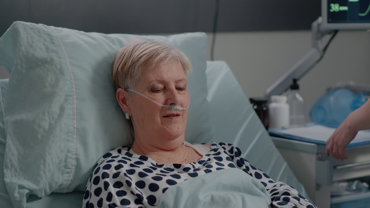 Aged patient with disease receiving visit from nurse