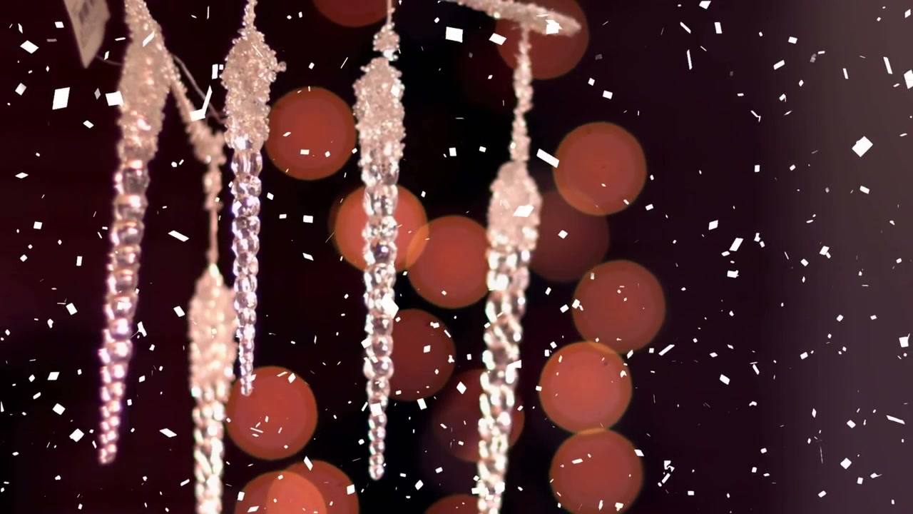 Animation af faldende sne over julepynt og lyspletter på sort baggrund