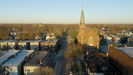 aerial establishing shot of st stephen's lutheran church in englewood, chicago at sunrise