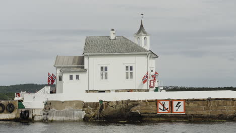 white lighthouse building on an island