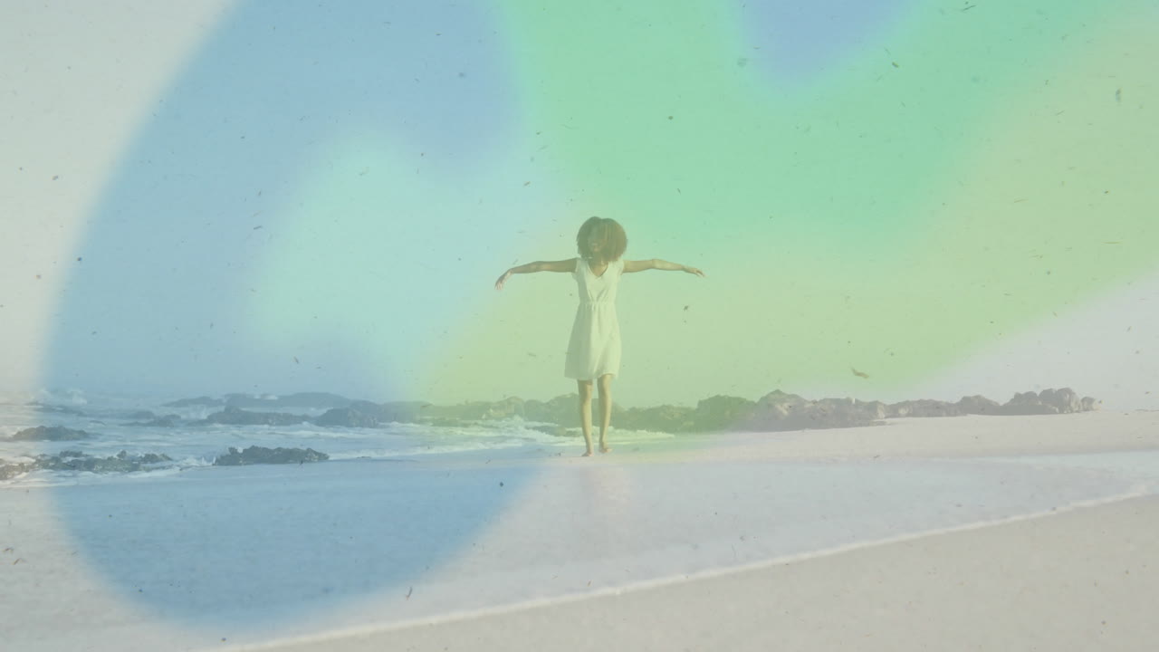 Dancing on beach, woman in white dress with colorful light animation overlay