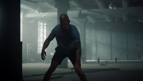 basketball player bouncing ball in sport club. sportsman dribbling ball in gym