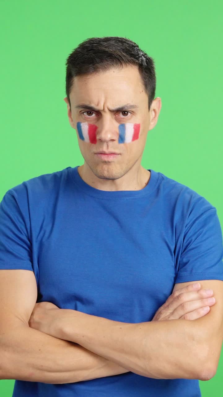 Dignified and serious man with french flag painted on face