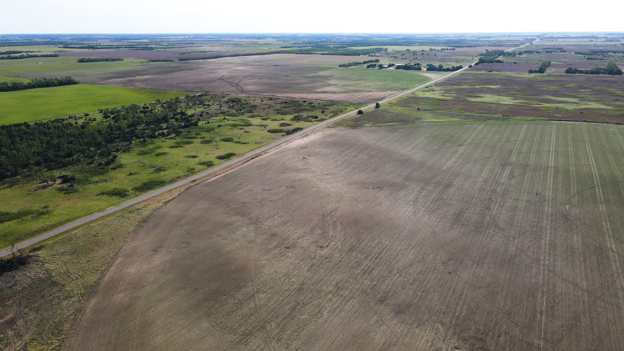 Aerial view over a swath, a row of fallen crop after a tornado in Kansas, USA