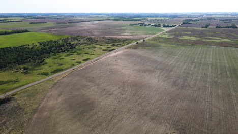 aerial view over a swath, a row of fallen crop after a tornado in kansas, usa