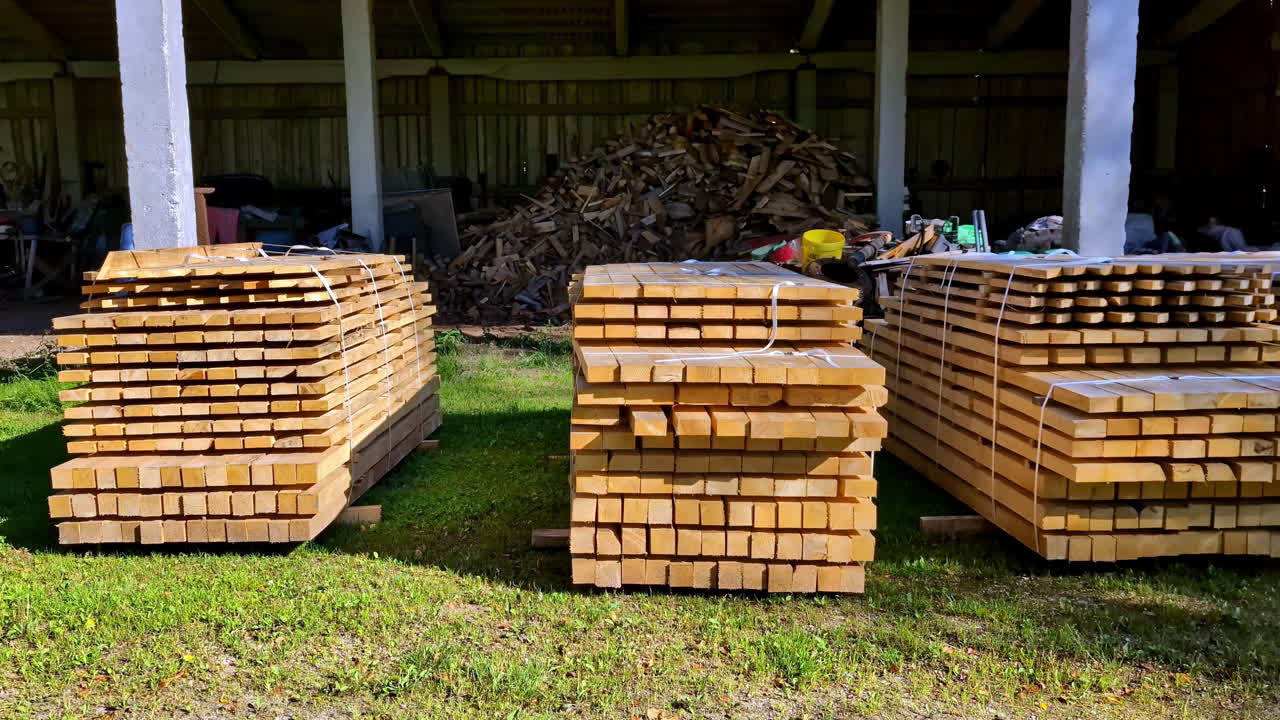 Raw wood planks drying near private barn, motion view
