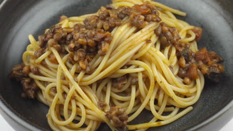 lentil pasta, vegan pasta, vegan spaghetti dish, spinning bowl of vegetarian pasta