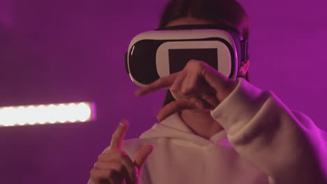 female using a vr headset on a colorful neon light background