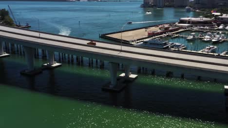 taxicab drives over bridge drone pan and tracks cab