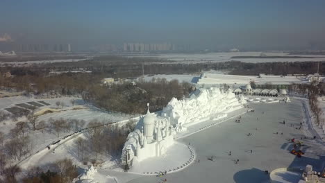 aerial spirals slowly over ice sculptures in winter city, harbin china