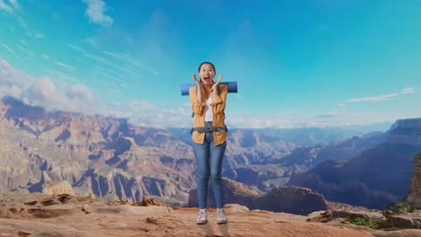 full body of asian female hiker with mountaineering backpack saying wow while traveling at the top of mountain
