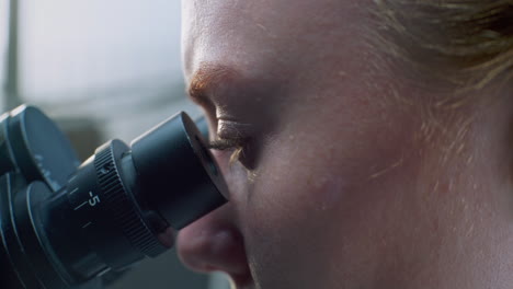 scientist using a microscope