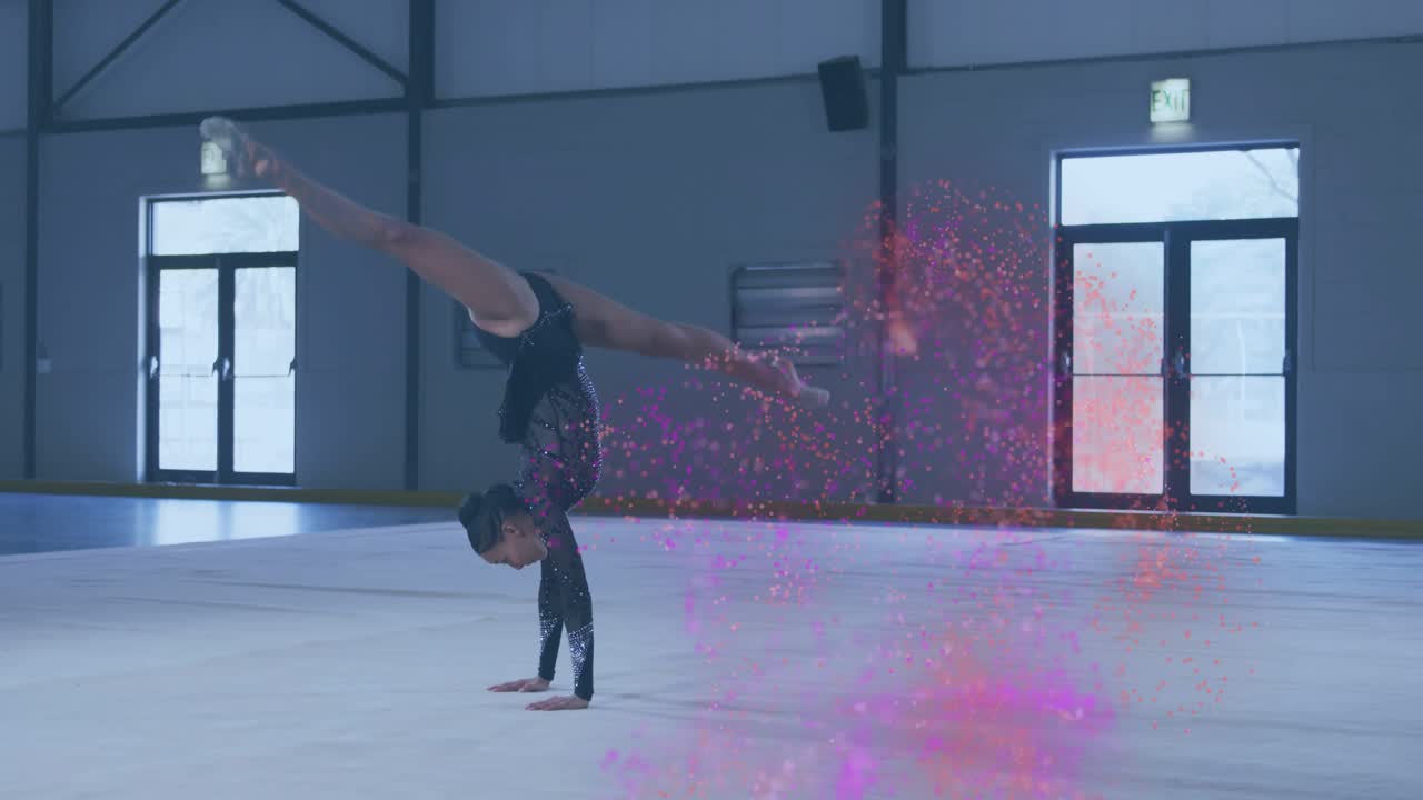 Gymnast entering frame doing floor routine arching into handstand cartwheel trailing pink sparkles