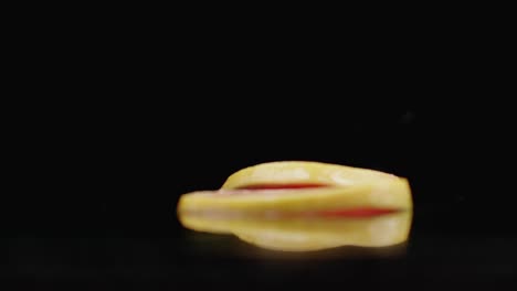 grapefruit rings sliced fall on the glass with splashes of water in slow motion.