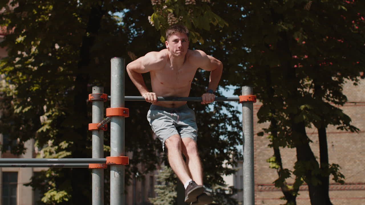 Athletic caucasian topless muscular training force push up pull up exercise strength gymnastics