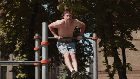 athletic caucasian topless muscular training force push up pull up exercise strength gymnastics