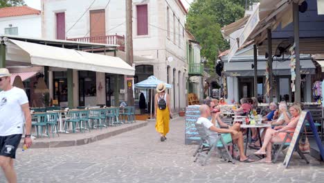 tourist at traditional greek taverna (cafe) in the streets of agiasos village, gimbal shot