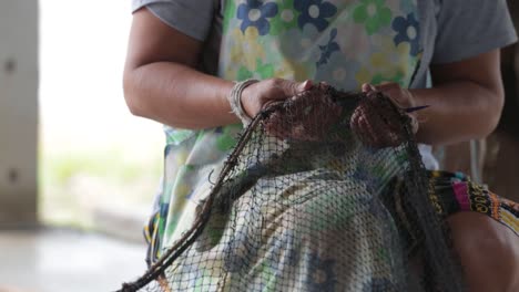 Close-Up-Footage-of-Farmer-Weaving-The-Fishing-Net