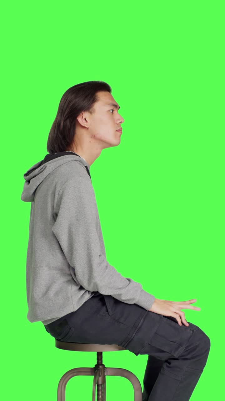 Profile of young man sitting on chair and waiting