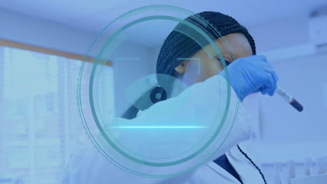 female lab technician examining blood sample holding test tube, showing digital interface overlay