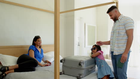 family packing suitcase on bed, preparing for vacation with smiles and excitement