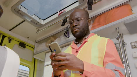 Close-Up-Of-American-Medical-Assistant-Texting-And-Using-His-Smartphone