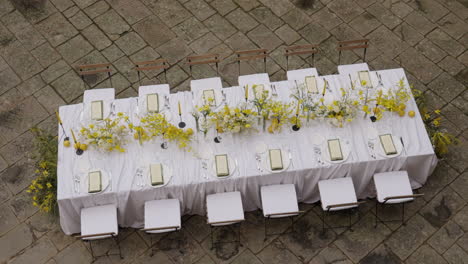elegant outdoor dining table setting with yellow flowers