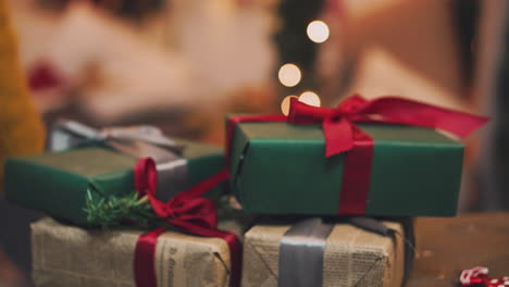 close-up-shot-of-the-men's-hands,-who-holds-beautifully-packaged-boxes-with-gifts,-the-person-will-put-them-under-the-tree-and-give-it-to-friends-or-family-during-the-celebration-of-the-new-year