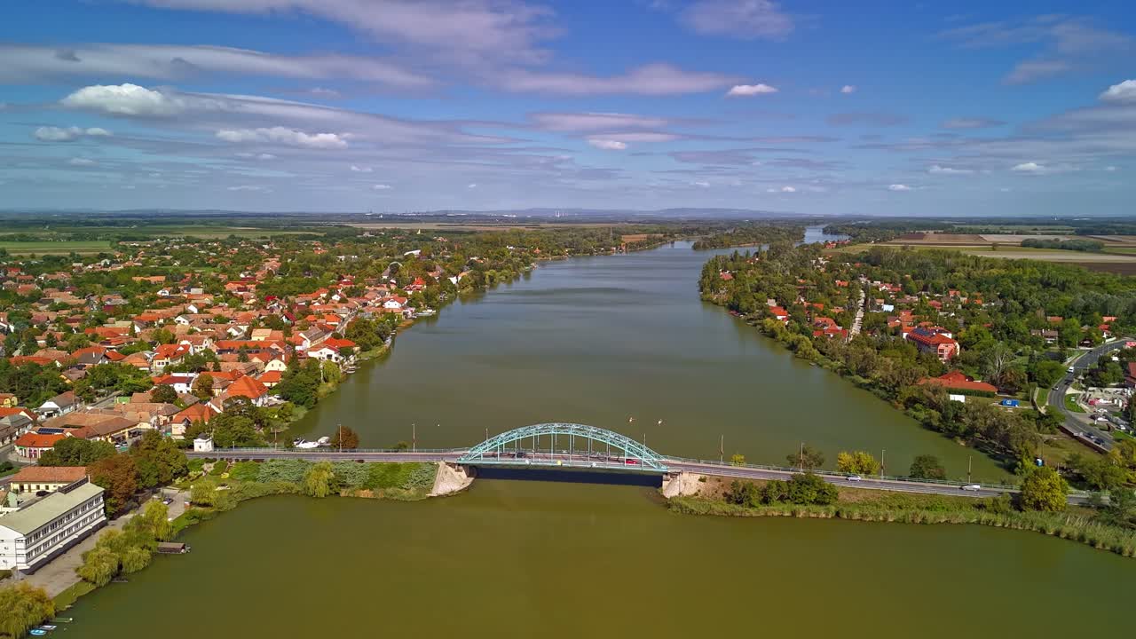 Aerial hyperlapse over the Danube River at Ráckeve with the daily traffic over the Árpád Bridge in Hungary