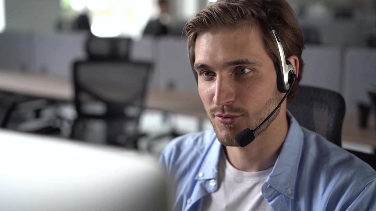 Young Man Working as Customer Support Representative in Office